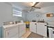 The laundry room features two washing machines, two dryers, a utility sink, and a ceiling fan at 4895 Bay Ne St # 207, St Petersburg, FL 33703