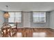 Bright living area featuring wood floors, a dining set, and natural light from large windows at 4895 Bay Ne St # 207, St Petersburg, FL 33703