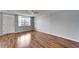 Open living space with hardwood floors, a ceiling fan, and sliding glass doors to a balcony at 4895 Bay Ne St # 207, St Petersburg, FL 33703