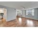Bright living area featuring hardwood flooring, a ceiling fan, and large windows with a view at 4895 Bay Ne St # 207, St Petersburg, FL 33703