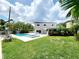 Beautiful backyard featuring a sparkling pool, jacuzzi, and lush landscaping at 5101 Dover Ne St, St Petersburg, FL 33703
