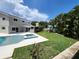 Expansive backyard featuring a pool, jacuzzi, and tropical landscaping at 5101 Dover Ne St, St Petersburg, FL 33703