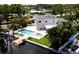 Aerial view of backyard with pool, spa, private dock, and lush tropical landscaping at 5101 Dover Ne St, St Petersburg, FL 33703