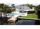 Backyard featuring a dock, pool, spa, and outdoor space at 5101 Dover Ne St, St Petersburg, FL 33703