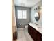 A full bathroom featuring a modern double sink vanity and marble countertop at 5101 Dover Ne St, St Petersburg, FL 33703