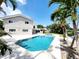 An exterior view showcases the modern pool and landscaped yard of the canal-front home at 5101 Dover Ne St, St Petersburg, FL 33703