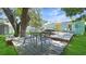 Charming backyard with a deck, seating area, and mature trees at 5119 23Rd S Ave, Gulfport, FL 33707