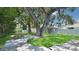Spacious backyard with a deck, lush lawn, and a storage shed at 5119 23Rd S Ave, Gulfport, FL 33707