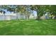 Spacious backyard featuring lush green grass, mature trees, and a storage shed at 5119 23Rd S Ave, Gulfport, FL 33707