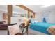 Cozy bedroom with a bright blue comforter, wood beams, and a peaceful ambiance at 5119 23Rd S Ave, Gulfport, FL 33707