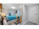 Well-lit bedroom with a blue comforter, wood beams, and a closet door at 5119 23Rd S Ave, Gulfport, FL 33707
