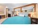 Comfortable bedroom with wood beams, a blue comforter, and ample lighting at 5119 23Rd S Ave, Gulfport, FL 33707