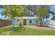 Charming turquoise home featuring a yellow door and manicured landscaping, creating a cheerful curb appeal at 5119 23Rd S Ave, Gulfport, FL 33707