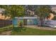 Charming turquoise home featuring a yellow door and manicured landscaping, creating a cheerful curb appeal at 5119 23Rd S Ave, Gulfport, FL 33707