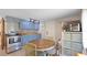 Kitchen featuring blue cabinets, stainless steel appliances, and a cozy dining area at 5119 23Rd S Ave, Gulfport, FL 33707