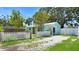 Rear view of turquoise home with white picket fence, offering outdoor charm at 5119 23Rd S Ave, Gulfport, FL 33707