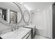 Elegant bathroom featuring double sinks with marble countertops and a modern shower at 5153 Isla Key S Blvd # 415, St Petersburg, FL 33715