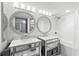 Elegant primary bathroom with dual mirrored vanities and modern fixtures at 5153 Isla Key S Blvd # 415, St Petersburg, FL 33715