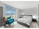 Serene bedroom with a comfortable bed, a turquoise chair, and beautiful natural light at 5153 Isla Key S Blvd # 415, St Petersburg, FL 33715