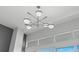 A stylish chandelier hangs above expansive windows that provide ample natural light at 5153 Isla Key S Blvd # 415, St Petersburg, FL 33715