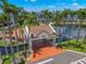 Aerial view of a charming entrance surrounded by lush palm trees and a pond at 5153 Isla Key S Blvd # 415, St Petersburg, FL 33715