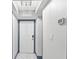 Hallway entrance with modern light fixture and white door with blue trim at 5153 Isla Key S Blvd # 415, St Petersburg, FL 33715