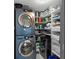 Well-stocked laundry room boasts a Samsung washer/dryer set and organized shelving at 5153 Isla Key S Blvd # 415, St Petersburg, FL 33715