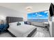 Bright main bedroom with a plush bed, water view, and a dedicated workspace at 5153 Isla Key S Blvd # 415, St Petersburg, FL 33715