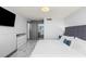 A luxury main bedroom with view to an ensuite bathroom, TV, and modern decor at 5153 Isla Key S Blvd # 415, St Petersburg, FL 33715