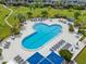 Aerial view of the large pool area, complete with lounge seating and shady umbrellas on a sunny day at 5153 Isla Key S Blvd # 415, St Petersburg, FL 33715