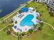 Aerial view of community pool with ample seating, landscaping, and proximity to building at 5153 Isla Key S Blvd # 415, St Petersburg, FL 33715