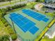 Aerial view of well-maintained tennis courts surrounded by greenery, providing an active recreational space at 5153 Isla Key S Blvd # 415, St Petersburg, FL 33715