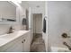 Bathroom features a sink vanity with storage, a toilet, and open doorway to an adjacent space at 520 34Th N Ave, St Petersburg, FL 33704