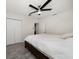 Bedroom features a ceiling fan, closet, and a large bed, wood-look tile floors at 520 34Th N Ave, St Petersburg, FL 33704