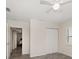 Bedroom features a ceiling fan, closet, and a view to the living area, wood-look tile floors at 520 34Th N Ave, St Petersburg, FL 33704