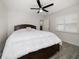 Bright bedroom features a ceiling fan, plantation shutters, and a large bed with built-in storage at 520 34Th N Ave, St Petersburg, FL 33704