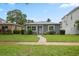 Charming single-story home with gray exterior, well-manicured lawn, and inviting walkway at 520 34Th N Ave, St Petersburg, FL 33704