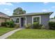 Charming single-story home with gray exterior, well-manicured lawn, and inviting walkway at 520 34Th N Ave, St Petersburg, FL 33704