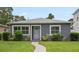 Charming single-story home with gray exterior, well-manicured lawn, and inviting walkway at 520 34Th N Ave, St Petersburg, FL 33704