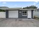 Exterior garage painted a dark gray color with a white garage door and white door at 520 34Th N Ave, St Petersburg, FL 33704