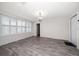 Bright living room features a decorative light fixture, wood-look tile flooring, and shuttered windows at 520 34Th N Ave, St Petersburg, FL 33704