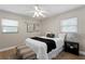 Cozy bedroom featuring neutral walls, light-colored floor, a bed with stylish pillows, and simple modern decor at 529 59Th S Way, St Petersburg, FL 33707