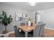 Well-lit dining room featuring a wooden table, gray chairs, and modern art at 529 59Th S Way, St Petersburg, FL 33707