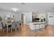 Open-concept layout with kitchen and dining area featuring hardwood floors and ample seating at 529 59Th S Way, St Petersburg, FL 33707