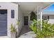 View of a home's front entrance, featuring decorative plants and house number at 529 59Th S Way, St Petersburg, FL 33707