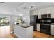 Modern kitchen with stainless steel appliances, granite countertops, and a breakfast bar at 529 59Th S Way, St Petersburg, FL 33707