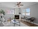 Inviting living room with a brick fireplace, cozy seating, and bright windows at 529 59Th S Way, St Petersburg, FL 33707