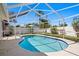 Sparkling pool surrounded by a screened enclosure and lush landscaping, perfect for relaxation and recreation at 529 59Th S Way, St Petersburg, FL 33707