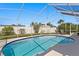Backyard featuring a screened pool with a patio area, plants, and a secure fenced perimeter at 529 59Th S Way, St Petersburg, FL 33707