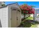 Exterior view of backyard shed near foliage and a screened in patio at 529 59Th S Way, St Petersburg, FL 33707
